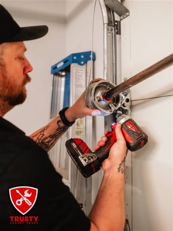 Technician servicing a garage door cable drum and bearing in North Richland Hills, TX