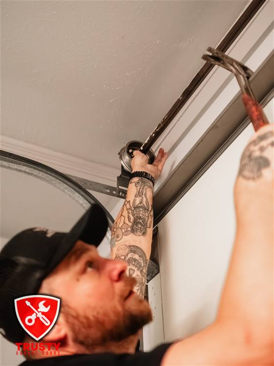 Technician fixing an off-track garage door in Plano, TX