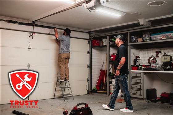 Trusty Garage Doors technicians performing a garage door tune-up and maintenance in Dallas, TX
